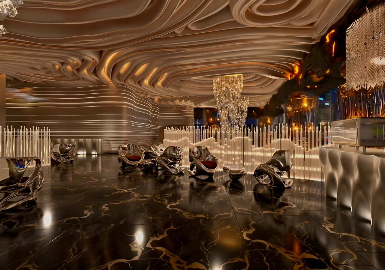 Lounge interior beneath a sculpted amber ribbon ceiling